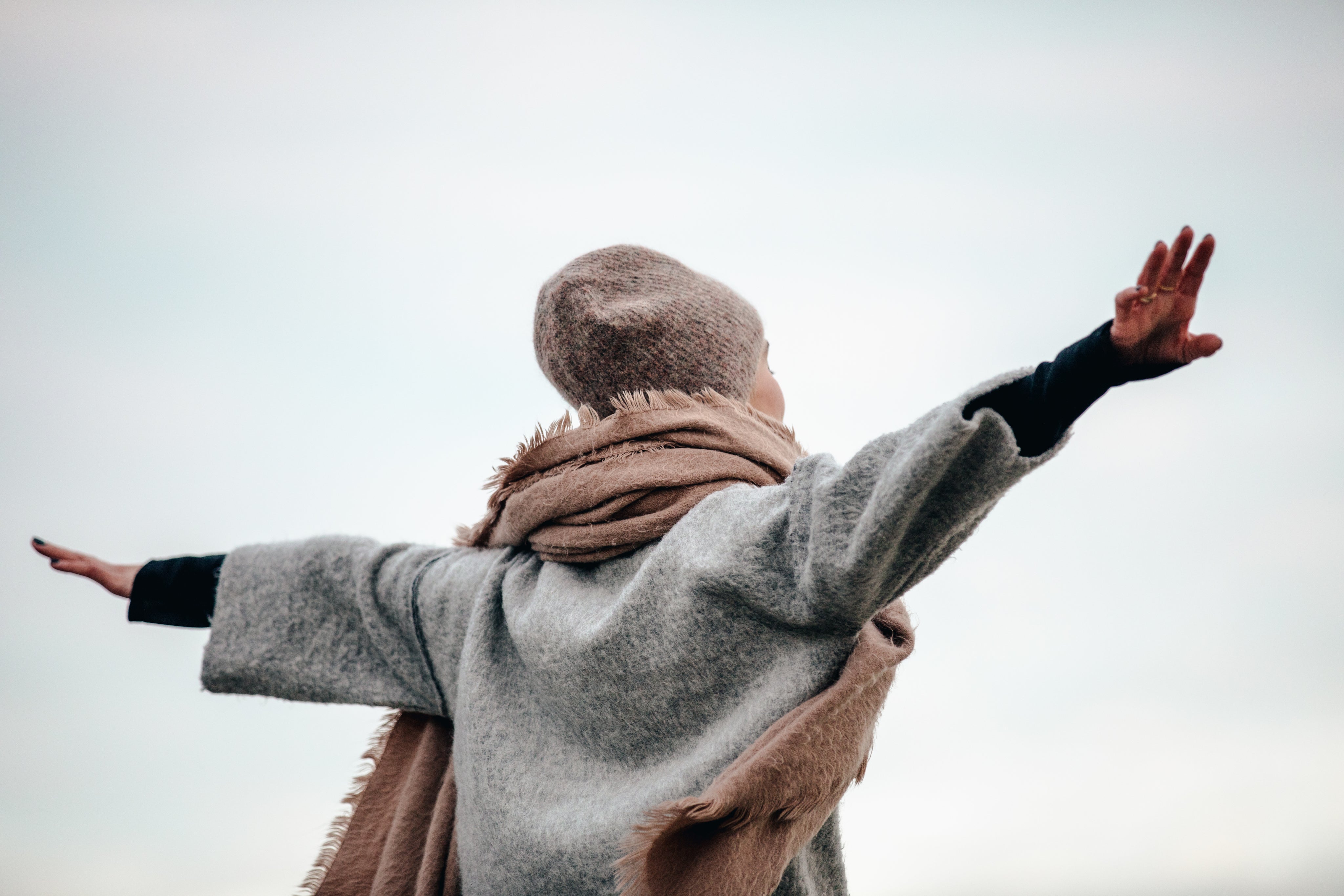 close-up-of-woman-spreading-arms-in-autumn-breeze.jpg